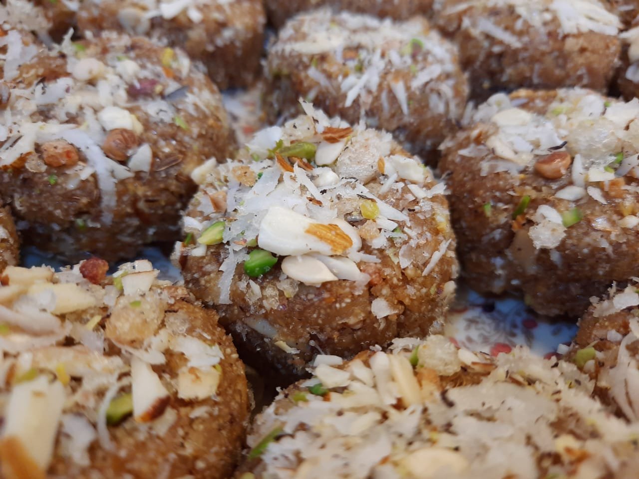 Fresh Zahra laddoos finished with nuts and coconut